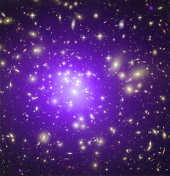 <p>The Galaxy cluster “Abell 1689”, located approximately 2 billion light years away, is one of the most massive clusters in the known Universe. This picture is a composite of an optical image, taken with the Hubble Space Telescope, and an X-ray observation with the Chandra Space Telescope. The former shows starlight from more than 1000 galaxies, the latter (in purple) the hundred-million-degree hot gas which permeates the space between galaxies and contributes more mass to the cluster than all its galaxies together.</p>