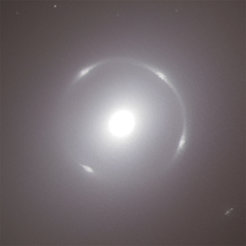 A bright, luminous point in the center with a circular, blurred halo, surrounded by dark space