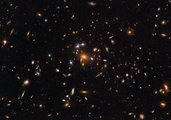 Dieses Bild zeigt einen entfernten Quasar, der durch eine Gravitationslinse in fünf Bilder abgebildet wird. Der Galaxienhaufen, der als Linse wirkt, wird SDSS J1004+4112 genannt und ist einer der entferntesten bekannten Galaxienhaufen (sieben Milliarden Lichtjahre, mit einer Rotverschiebung z=0.68). Astronomen verwenden dieses Phänomen um mehr über die Eigenschaften der dunklen Materie zu erfahren.