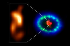 Extrem hochauflösende ALMA-Bilder zeigen einen heißen "Klecks" im staubigen Kern der Supernova 1987A (Ausschnitt), der der Ort des vermissten Neutronensterns sein könnte. Die rote Farbe zeigt Staub und kaltes Gas im Zentrum des Supernova-Überrests, aufgenommen bei Radiowellenlängen mit ALMA. Die grünen und blauen Farbtöne verraten, wo die sich ausdehnende Stoßwelle des explodierten Sterns mit Material rund um die Supernova kollidiert. Das Grün steht für sichtbares Licht, das vom Hubble-Weltraumteleskop der NASA aufgenommen wurde. Die blaue Farbe zeigt das heiße Gas und basiert auf Daten des Chandra-Röntgenobservatoriums der NASA. Der Ring wurde ursprünglich durch den Lichtblitz der Explosion zum Leuchten gebracht. In den folgenden Jahren wurde das Ringmaterial erheblich heller durch die Stoßwelle der Explosion, die auf den Ring getroffen war.